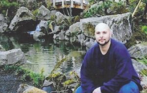 Oregon Prison Pen Pal King Victorious sitting by water
